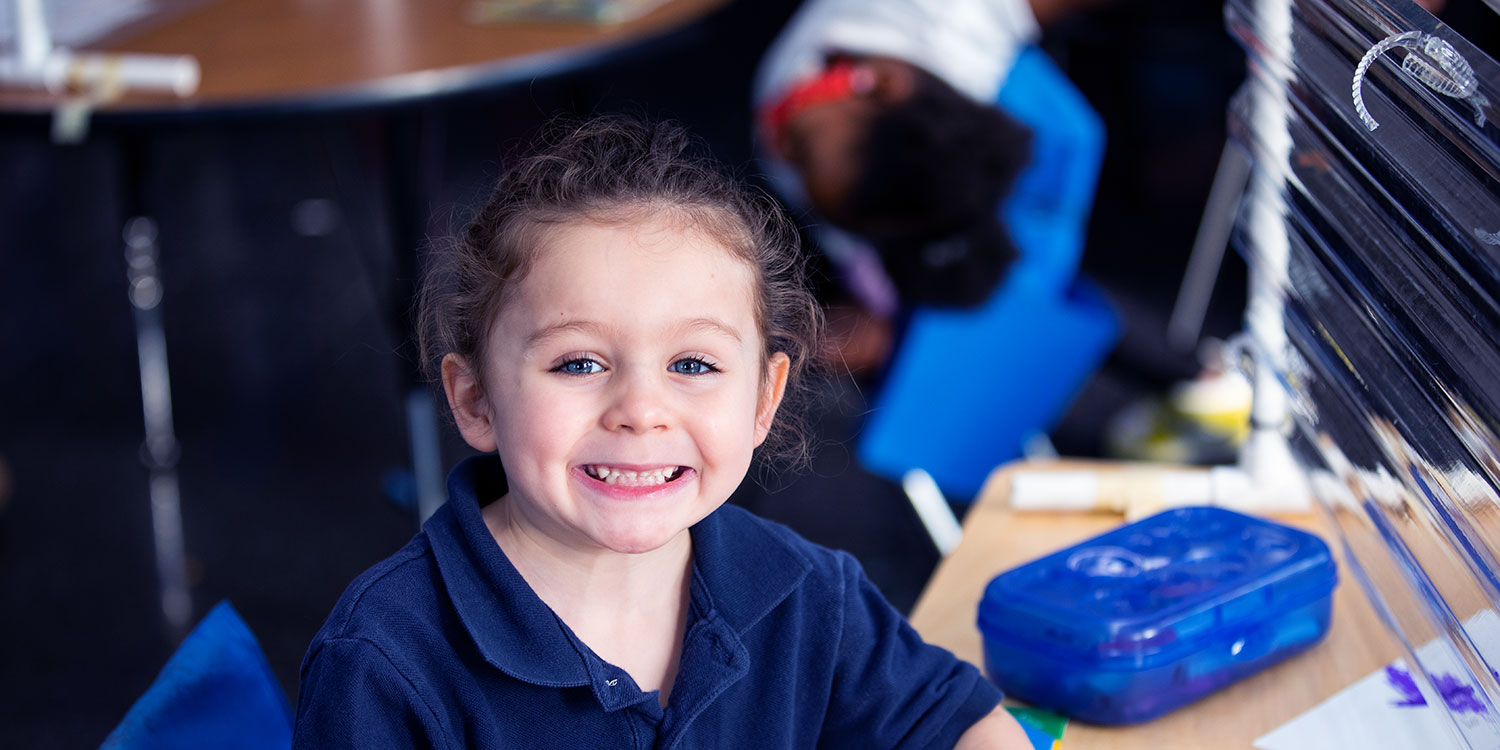 Smiling student in classroom.